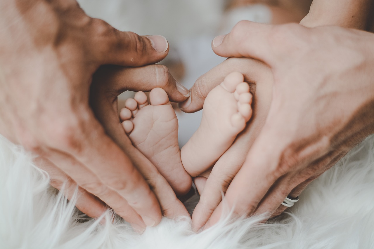 Family hands and baby feet